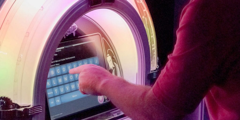 Picking a track on the jukebox in the Conservatory bar