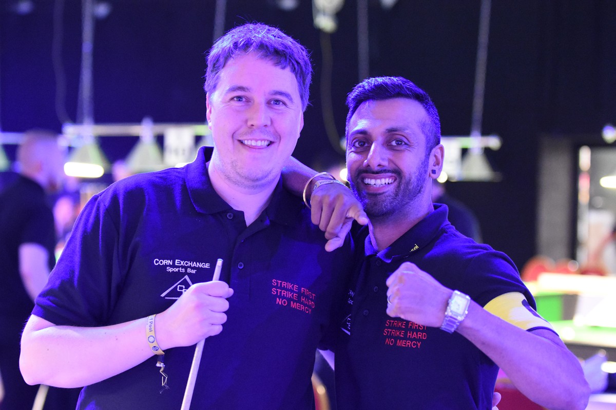 Two team mates in matching shirts in the arena